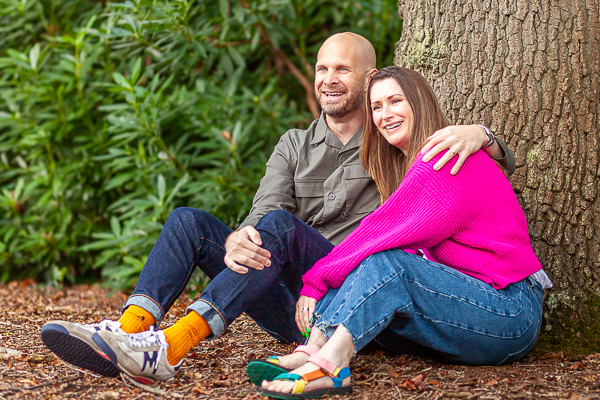 Couple wearing colourful outfits including a bright pink jumper during an outdoor family photoshoot in Fleet Hampshire