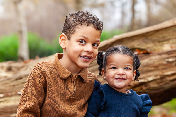 children wearing brown and navy outfits for outdoor family photoshoot UK